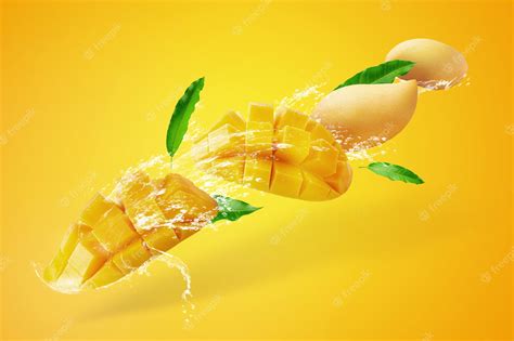 Premium Photo Water Splashing On Fresh Sliced Mango Fruit With Mango Cubes Isolated On Yellow