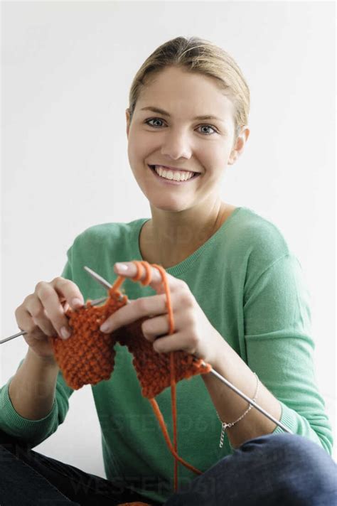 Portrait Of Young Woman Knitting Stock Photo