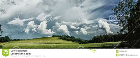 Scenic Landscape With Storm Cloud In Background Over Green Agriculture