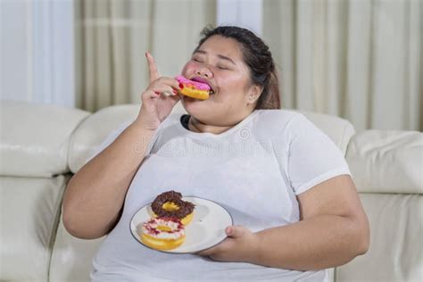 Overweight Woman Eating Doughnuts With Pleasure Stock Photo Image Of Junk Girl