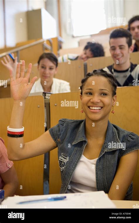 Female Student Raising Hand In Class Stock Photo Alamy