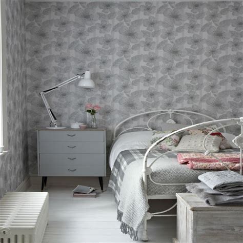 This beautiful wallpaper has a modern geometric design with a pink and grey triangles and is finished with metallic highlights. Understated grey walllpaper | Bedroom wallpaper ideas | housetohome.co.uk