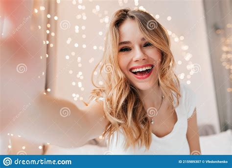 Gorgeous Fair Haired Girl Taking Picture Of Herself While Resting In Her Room Indoor Photo Of
