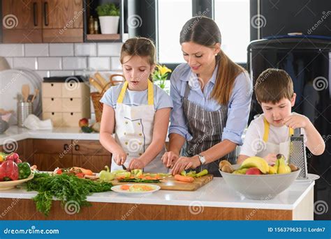 Mother Teaching Kids To Cook And Help In The Kitchen Stock Image