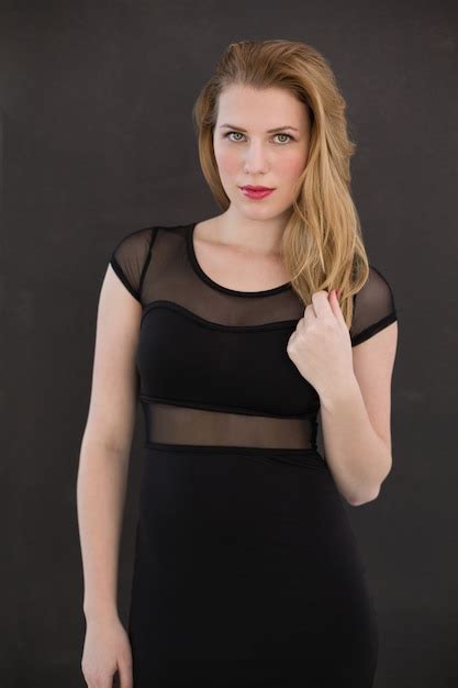premium photo pretty blonde wearing sexy black dress posing