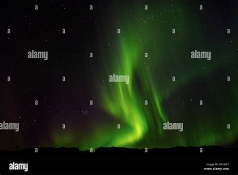 Green Aurora Borealis Northern Lights Display Against A Night Starry