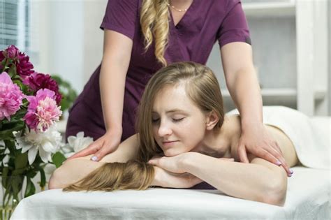 premium photo beautiful happy woman lies in spa salon and enjoys professional massage