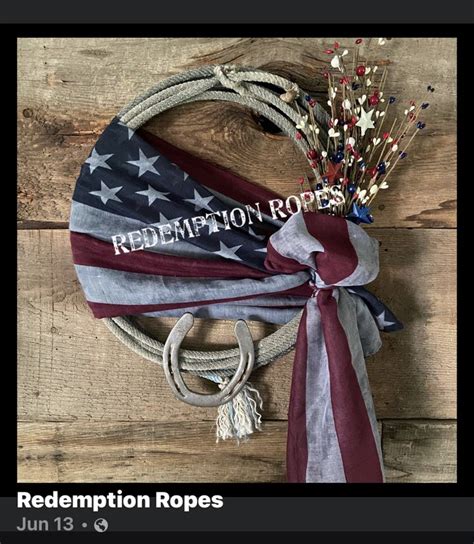 A Wreath With An American Flag And Rope Tied To It On Top Of A Wooden Wall