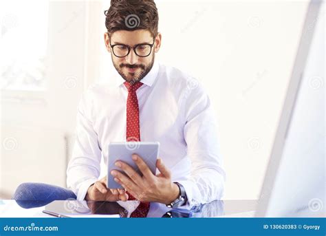 Businessman Using Digital Tablet While Working At Office Desk Stock