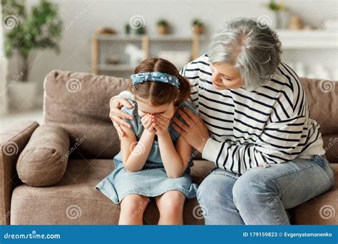 Grandmother Supporting Crying Granddaughter At Home Stock Image Image