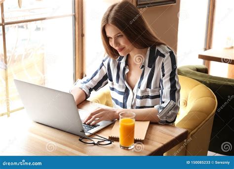 Young Freelancer With Laptop Working In Cafe Stock Image Image Of