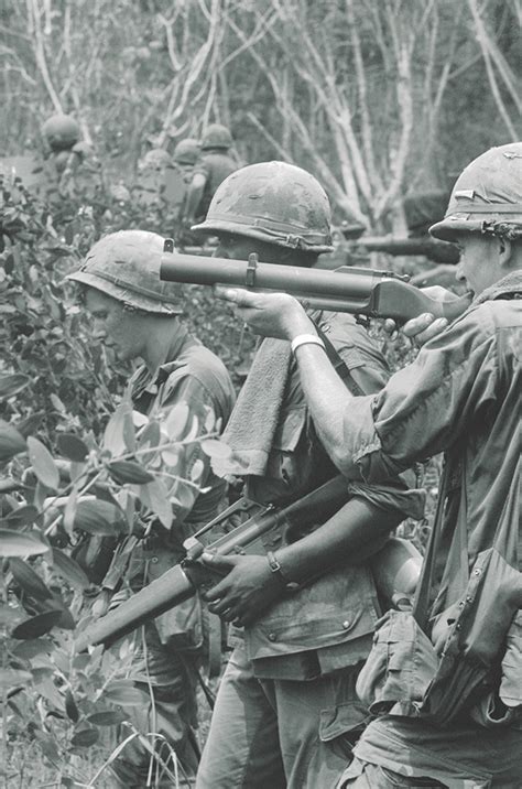 Troops Of The 1st Infantry Division Near Right Are Covered By An M79 As They Advance Through A
