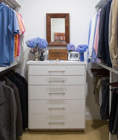 His Closet Boasts Stacked Clothing Rails Positioned On Either Side Of A