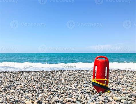 Red Rescue Float On Rocky Beach With Sea Panorama And No Lifeguard