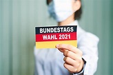 A woman in face mask holds German flag - Bundestagswahl 2021 - Creative ...
