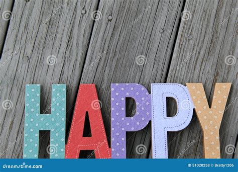 Colorful Cut Out Words That Read Happy On Wood Background Stock Photo
