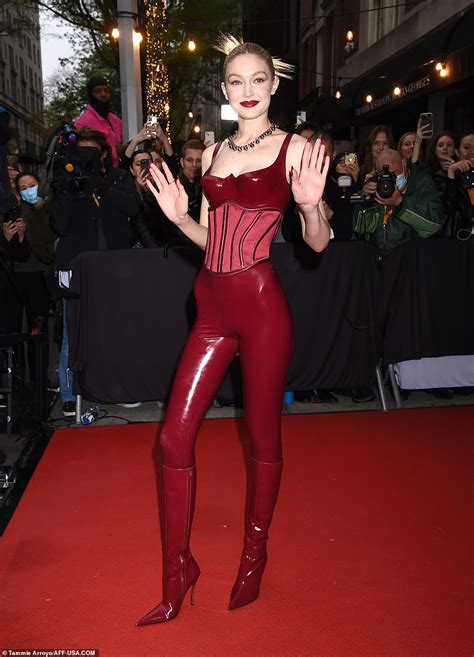 gigi hadid slays at the met gala rocking a red latex catsuit and corset like a total boss