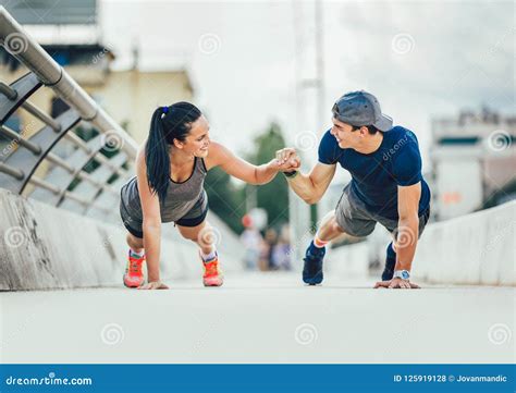 Couple Doing Push Ups Outdoors On The Bridge Stock Photo Image Of