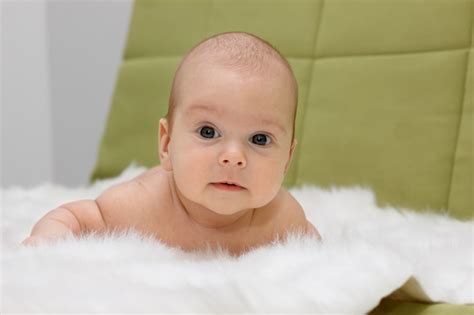 Premium Photo Baby Lying On A White Fur