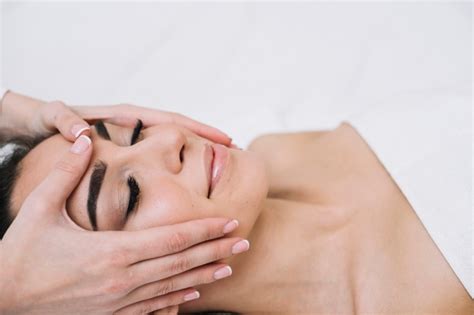 Woman Receiving A Relaxing Facial Massage Photo Free Download