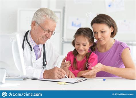 Mom And Daughter At An Appointment With An Doctor Stock Photo Image