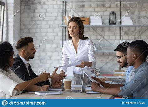 Serious Executive Businesswoman Manager Gives Handout In Boardroom At