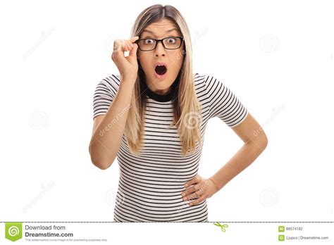 Baffled Young Woman With Eyeglasses Looking At The Camera Stock Photo