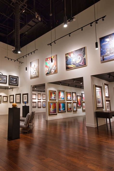 A Large Room Filled With Framed Pictures And Art Work On The Walls