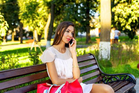 Beautiful Girl Sitting On A Bench Brunette In Pink Dress Fashion Lifestyle Talking To The
