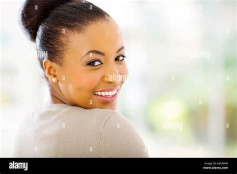 Portrait Of Cheerful African American Woman Looking Back Stock Photo