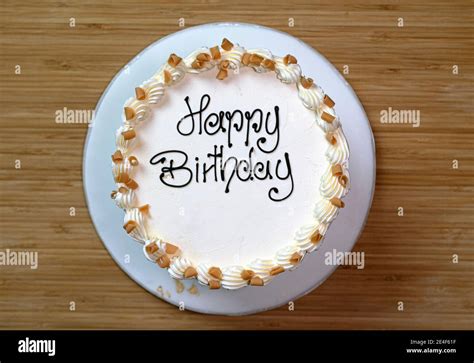 White Gourmet Birthday Cake With A Happy Birthday Sign Frosted With