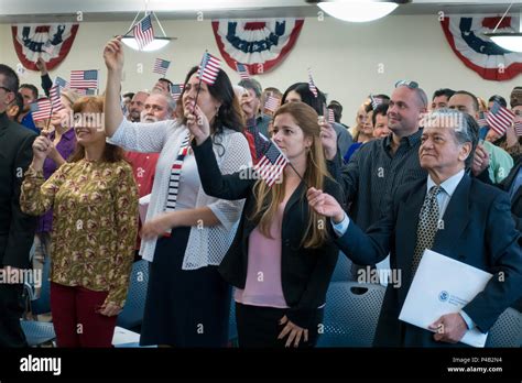 Just Sworn In As American Citizens Immigrants Wave Flags And Hold