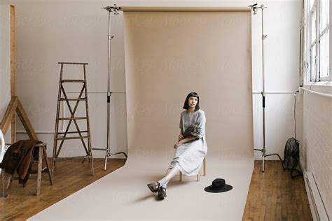 Behind The Scenes Of Model Sitting In Front Of Backdrop Seamless Paper