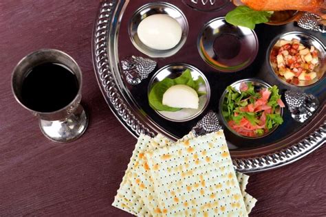 premium photo matzo for passover with seder meal with wine on plate on table close up