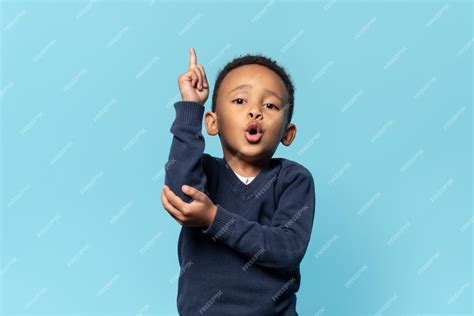 Premium Photo Funny Black Kid Little Boy Holding Finger Up And