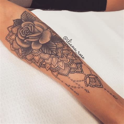 A Woman S Arm With A Rose Tattoo On It