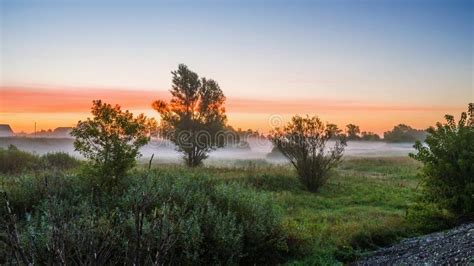 Morning Mist At Dawn Before Sunrise Near The Village Stock Photo