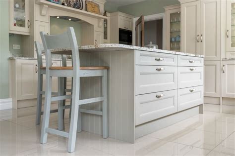 An Island With An Overhang For Seating In This Painted Kitchen With A