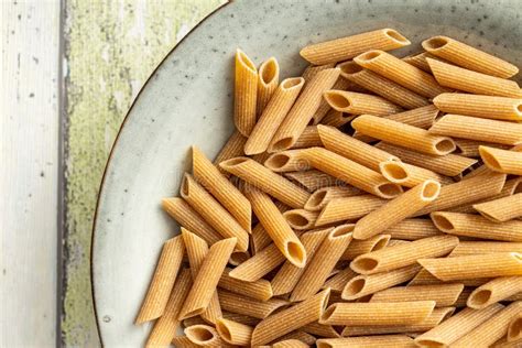 Uncooked Whole Grain Pasta Raw Penne Pasta In Plate Top View Stock