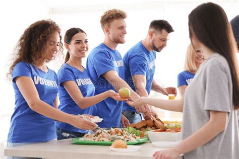 Volunteers Serving Food To People Indoors Stock Image Image Of Giving