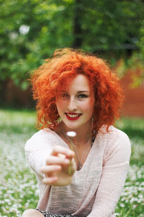 Beautiful Ginger Woman Holding A Flower And Smiling By Stocksy