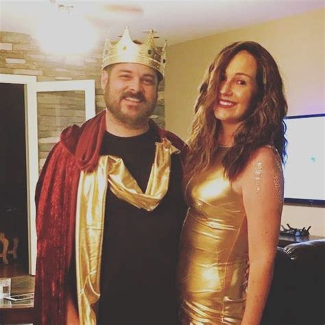The Man And Woman Are Dressed Up As King And Queen In Gold Outfits