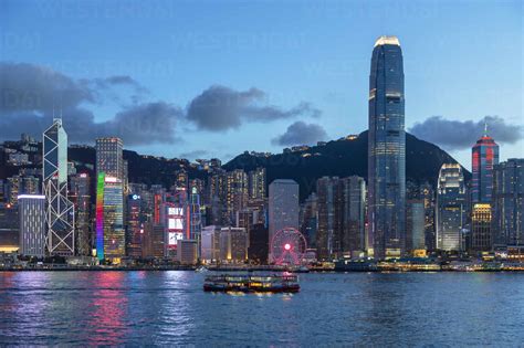 Star Ferry In Victoria Harbour And Skyline Of Hong Kong Island At Dusk
