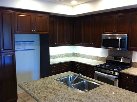 The color on the kitchen tile has a slight hint of blue to give it some interest. What color floor with dark cabinets? (hardwood floor ...