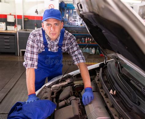 Positive Man Car Mechanician Repairing Car In Auto Repair Service Stock