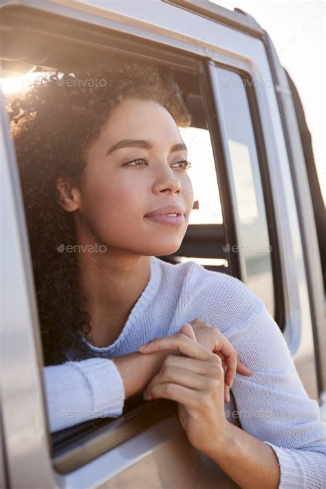 Woman Looking Out Of Front Passenger Car Window Vertical Car Window