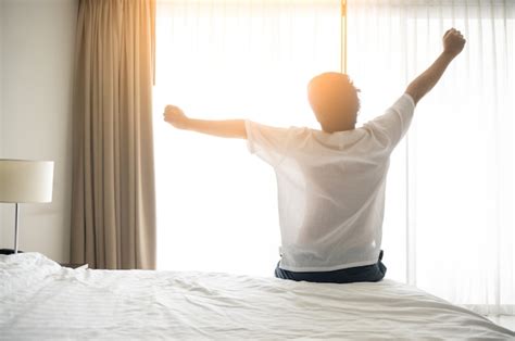 Premium Photo Man Wake Up And Stretching In Morning With Sunlight