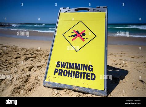 Yellow No Swimming Sign On A Beach Stock Photo Alamy