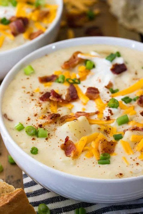 A Close Up View Of Creamy Potato Soup Topped With Bacon Sour Cream