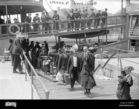 European Immigrants Disembarking At Ellis Island Ca 1907 Stock Photo